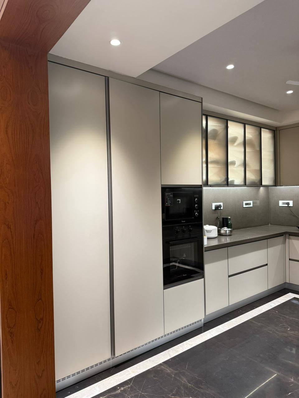 Tall kitchen pantry unit with integrated microwave and oven
