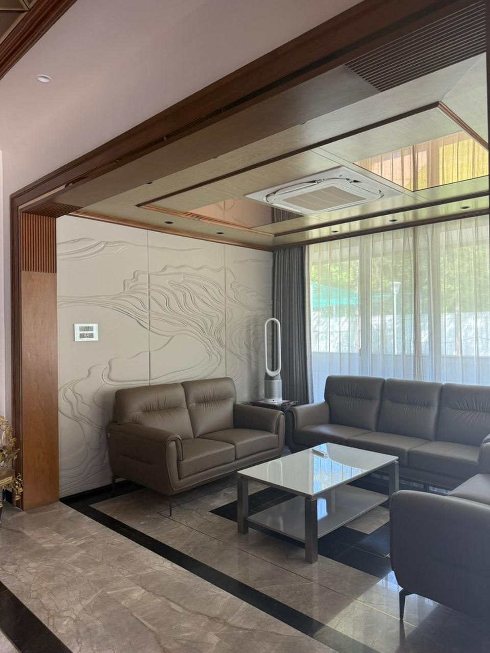 Living room side angle showing sheer drapery, ceiling AC unit, and marble flooring